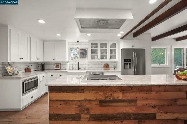 a kitchen with stainless steel appliances granite countertop a stove and a sink
