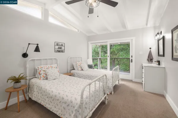 a bedroom with a bed and a large window