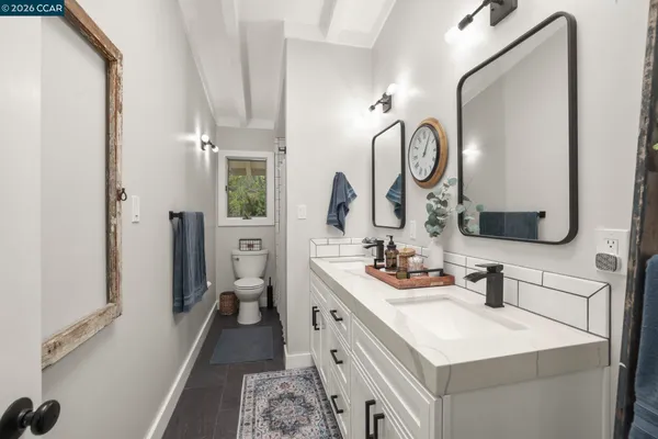 a en suite bathroom with a double vanity sink and a mirror