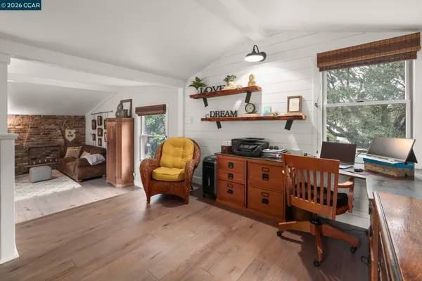 a bedroom with furniture and a window
