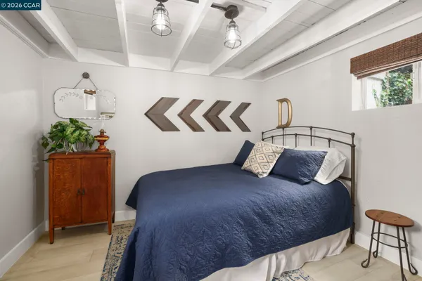 a bedroom with a bed and a potted plant