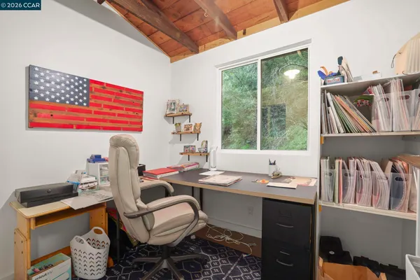 a room with furniture a rug toys and windows