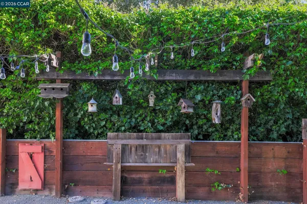 a view of small yard with wooden fence