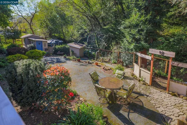 a backyard of a house with yard and outdoor seating