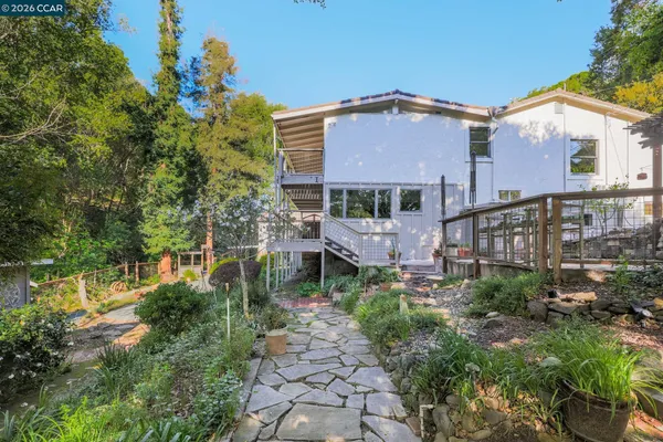 a view of a house with a yard and plants