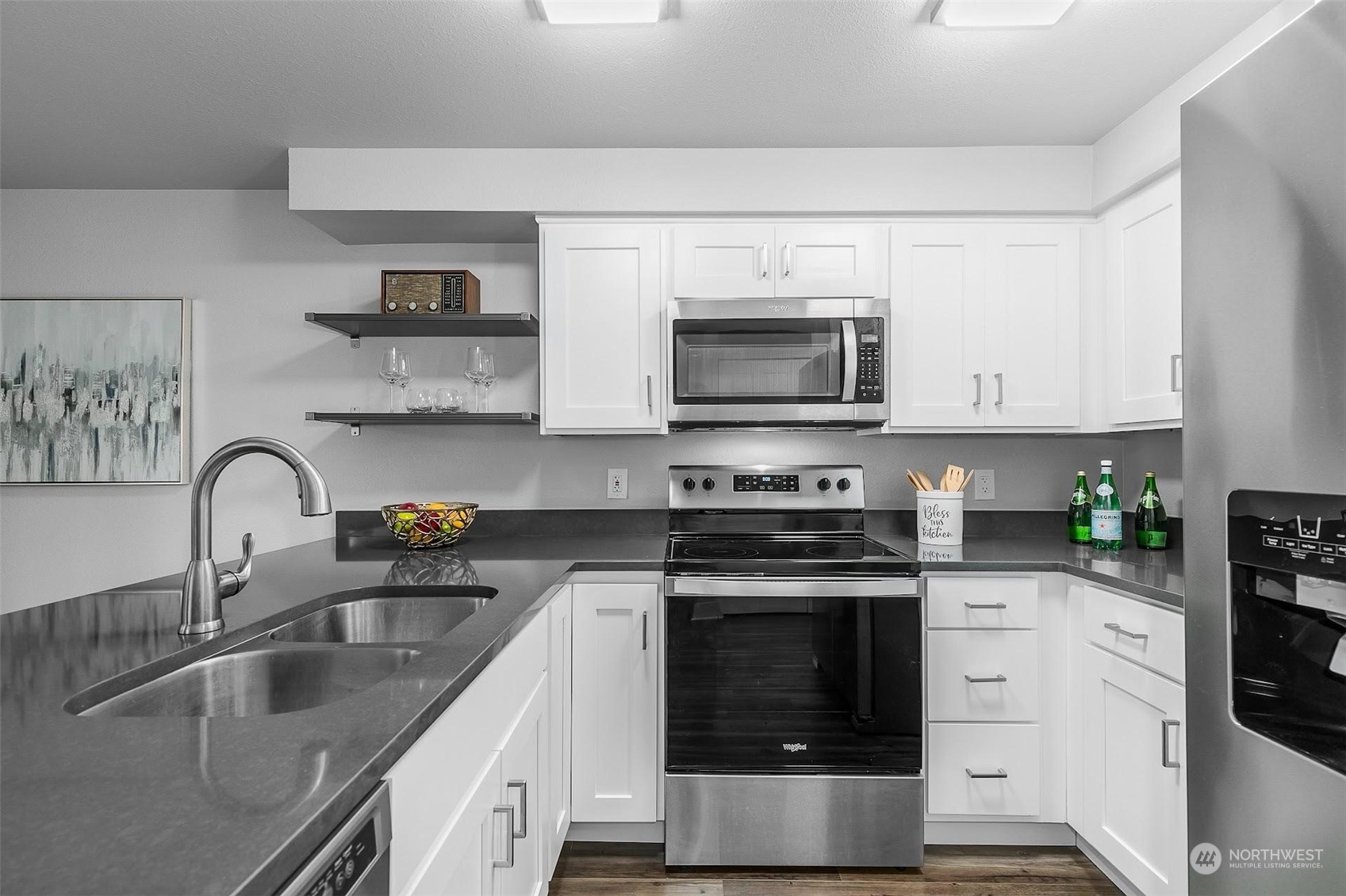 19404 Bothell Way Northeast, Unit B303 Bothell, WA 98011 - Photo 14 of 27 a kitchen with stainless steel appliances a stove a sink a microwave and cabinets