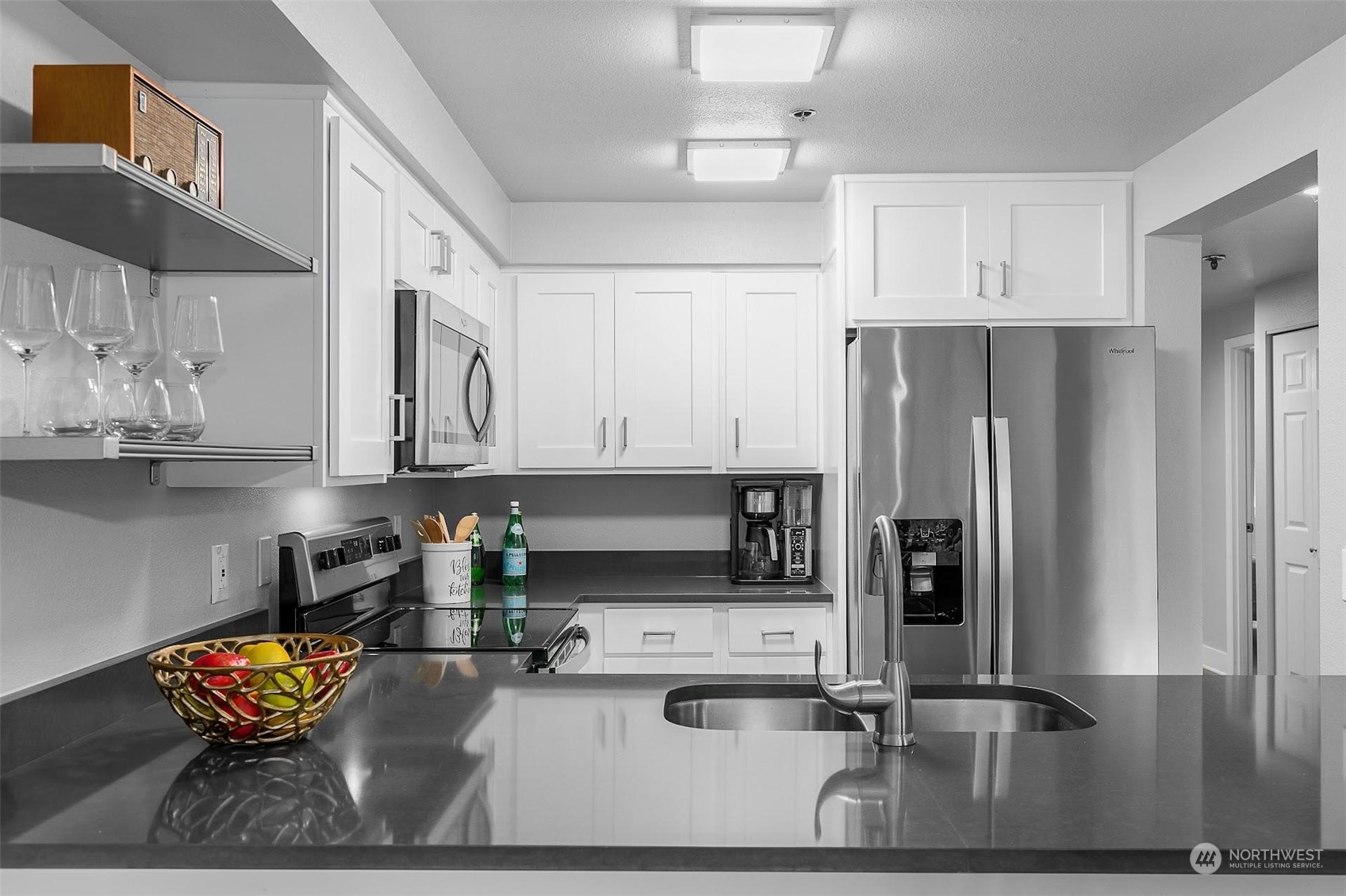 19404 Bothell Way Northeast, Unit B303 Bothell, WA 98011 - Photo 16 of 27 a kitchen with stainless steel appliances granite countertop a sink refrigerator and cabinets
