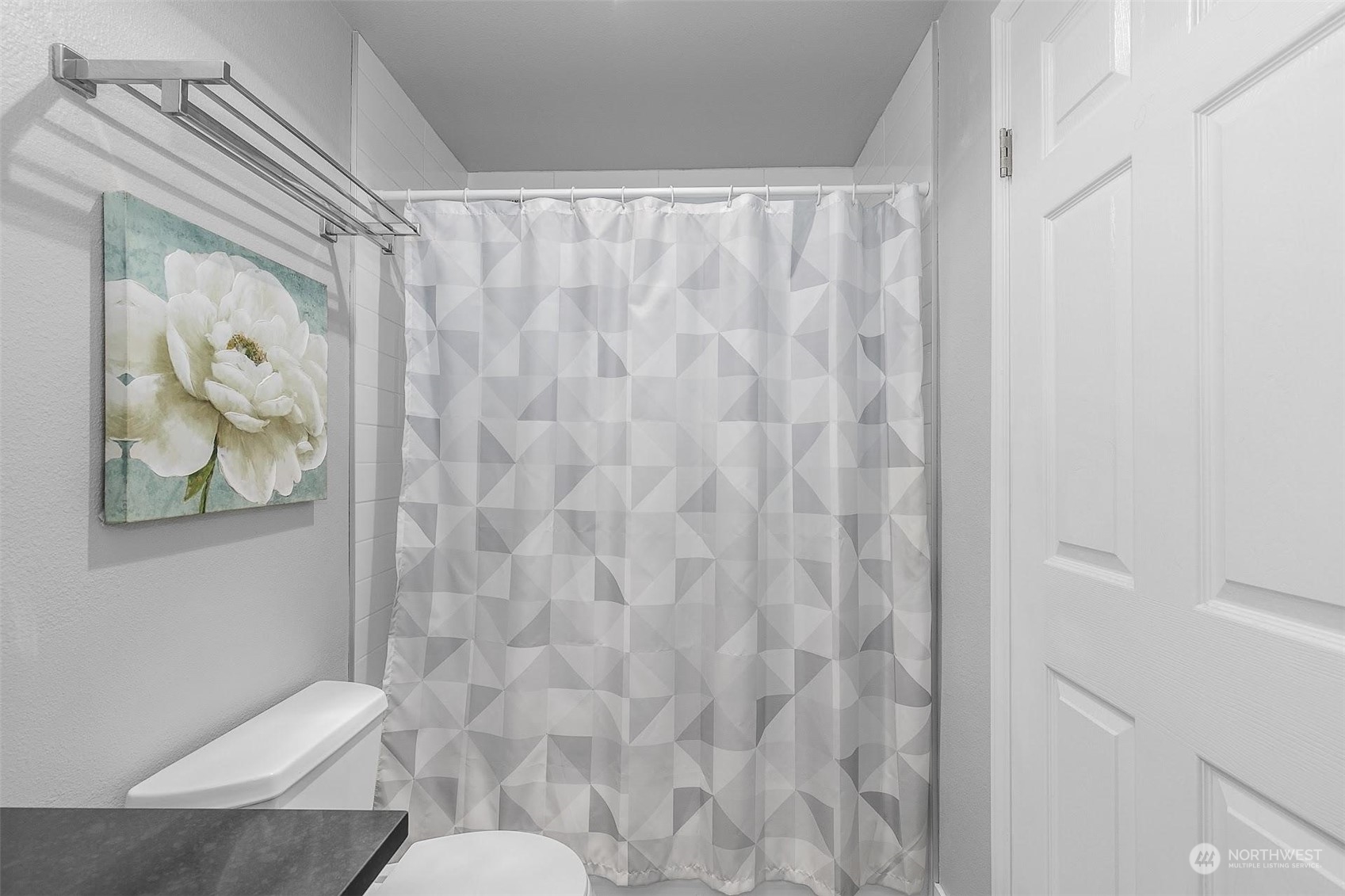 19404 Bothell Way Northeast, Unit B303 Bothell, WA 98011 - Photo 20 of 27 a white toilet sitting next to a shower curtain
