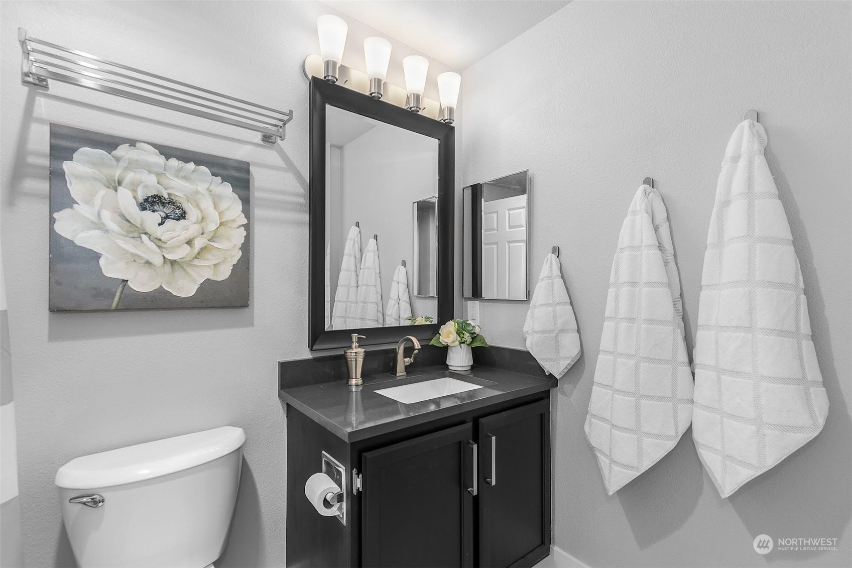 19404 Bothell Way Northeast, Unit B303 Bothell, WA 98011 - Photo 24 of 27 a bathroom with a sink a toilet and a mirror