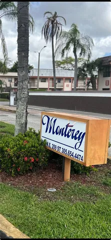a view of a street with potted plants