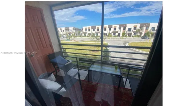 a view of a balcony with two chairs and a table
