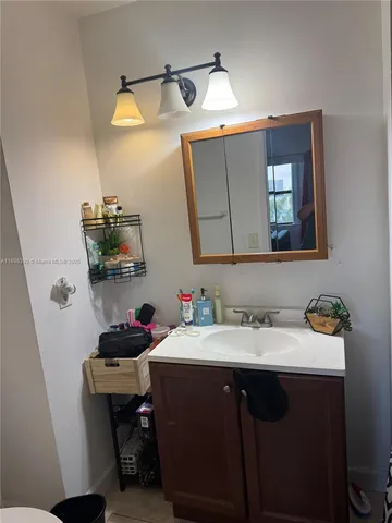 a bathroom with a sink vanity and a mirror