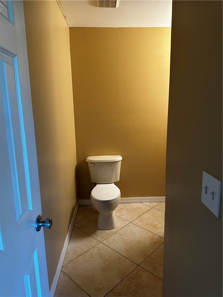93 Spring Lake Drive, Unit 202 Vero Beach, FL 32962 - Photo 11 of 18 a bathroom with a toilet and a sink