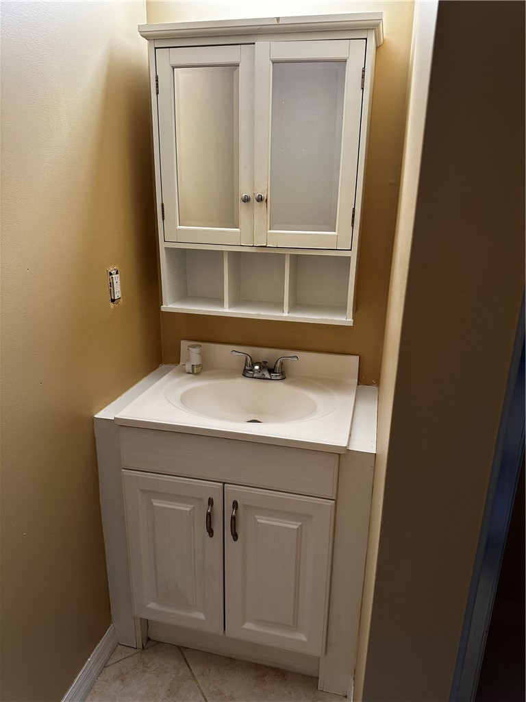 93 Spring Lake Drive, Unit 202 Vero Beach, FL 32962 - Photo 13 of 18 a bathroom with a sink and a mirror