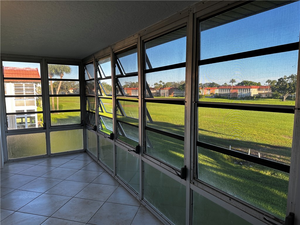 93 Spring Lake Drive, Unit 202 Vero Beach, FL 32962 - Photo 14 of 18 a view of a large window with an outdoor space