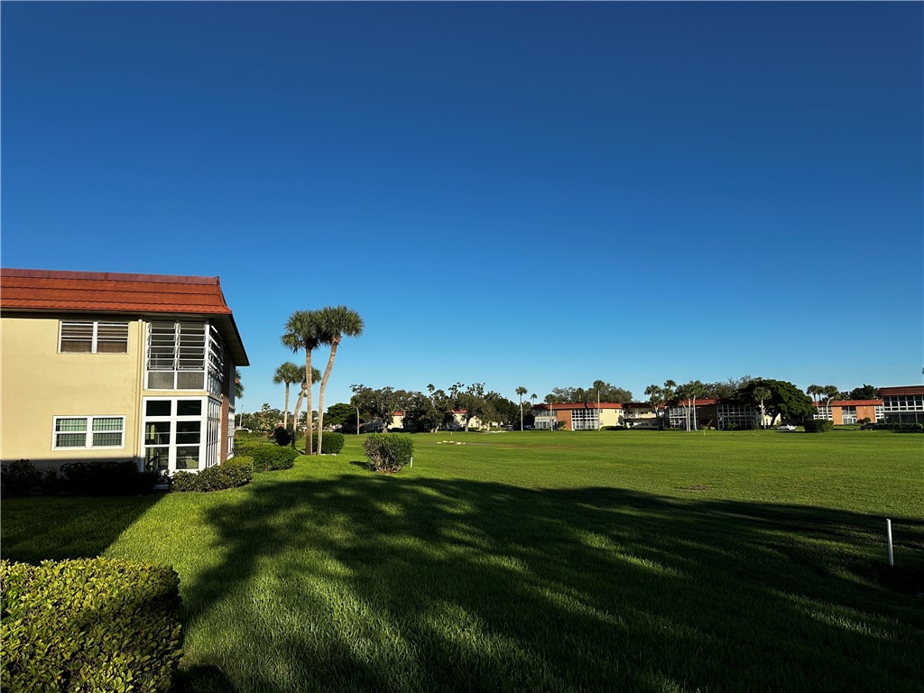 93 Spring Lake Drive, Unit 202 Vero Beach, FL 32962 - Photo 3 of 18 a view of a house with a big yard