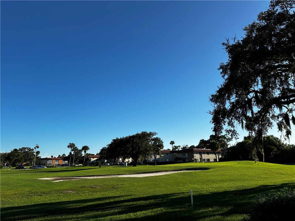 93 Spring Lake Drive, Unit 202 Vero Beach, FL 32962 - Photo 4 of 18 a view of a golf course with a lake