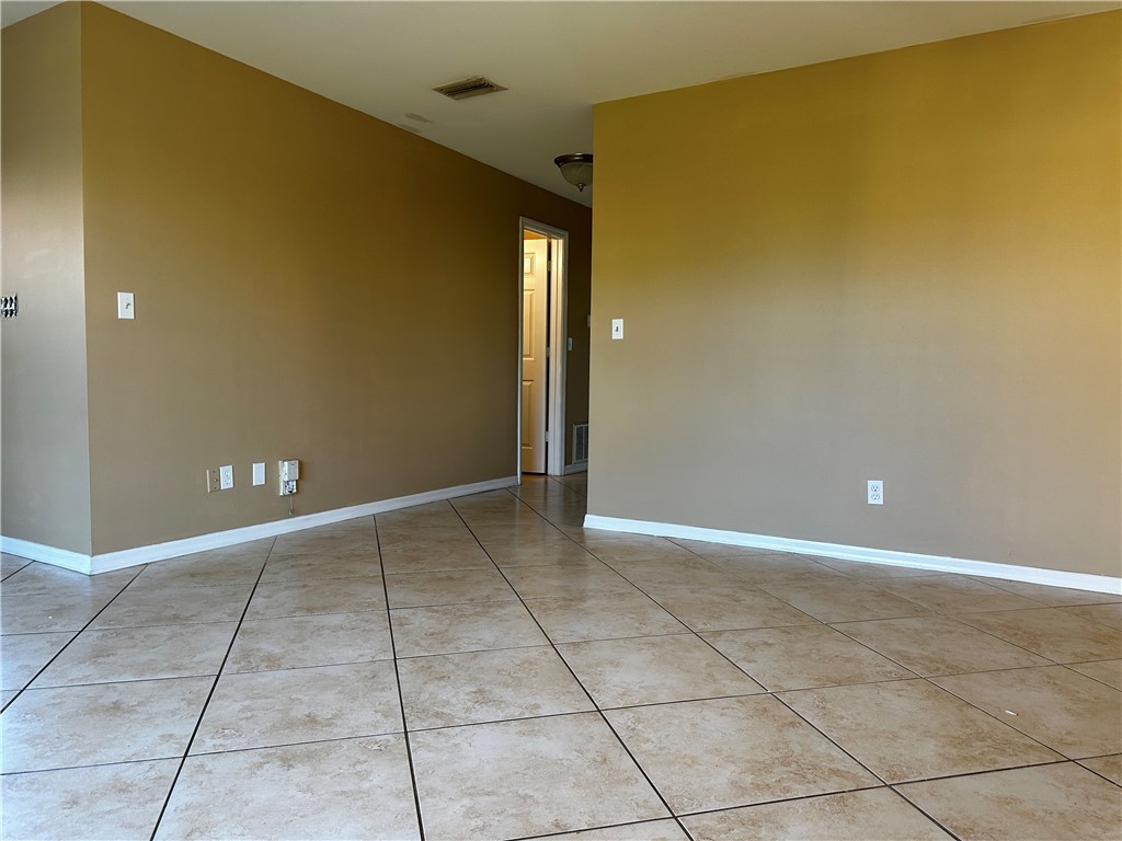 93 Spring Lake Drive, Unit 202 Vero Beach, FL 32962 - Photo 5 of 18 a view of an empty room with windows