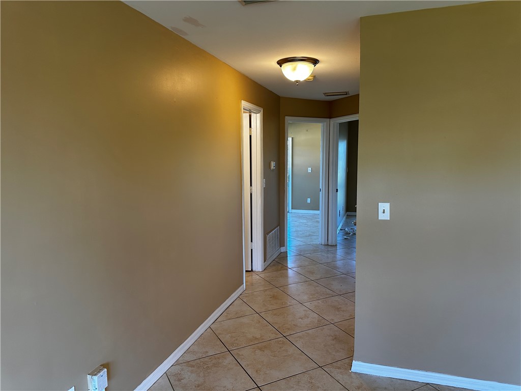 93 Spring Lake Drive, Unit 202 Vero Beach, FL 32962 - Photo 7 of 18 a view of a hallway with wooden floor