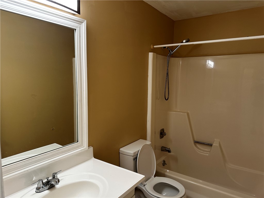 93 Spring Lake Drive, Unit 202 Vero Beach, FL 32962 - Photo 8 of 18 a bathroom with a sink and a mirror