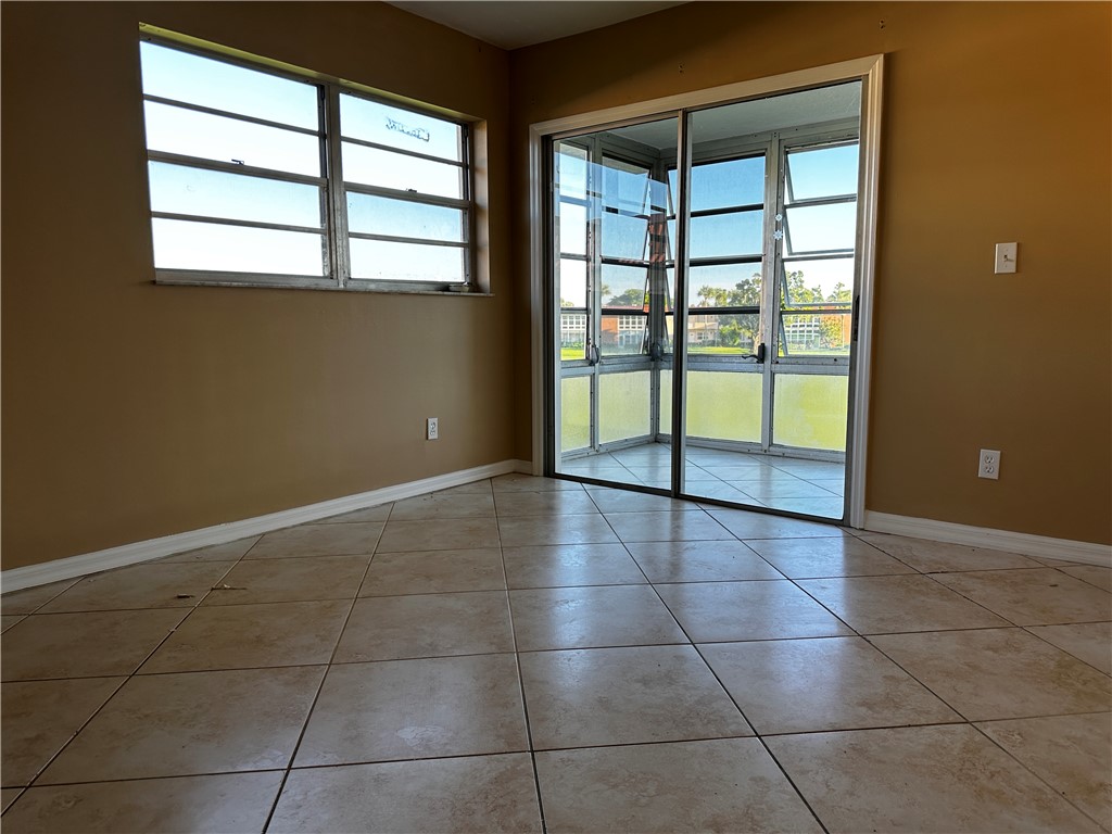 93 Spring Lake Drive, Unit 202 Vero Beach, FL 32962 - Photo 9 of 18 a view of an empty room with a window
