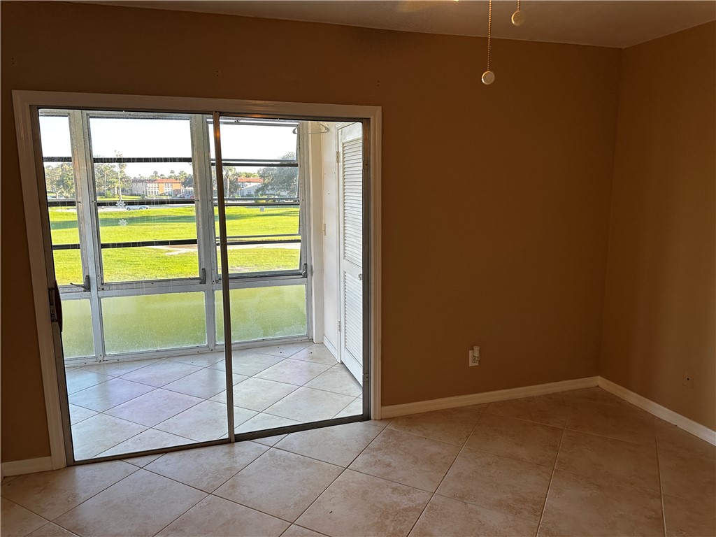 93 Spring Lake Drive, Unit 202 Vero Beach, FL 32962 - Photo 10 of 18 a view of an empty room and window
