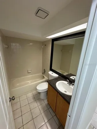 a bathroom with a toilet a sink and bathtub