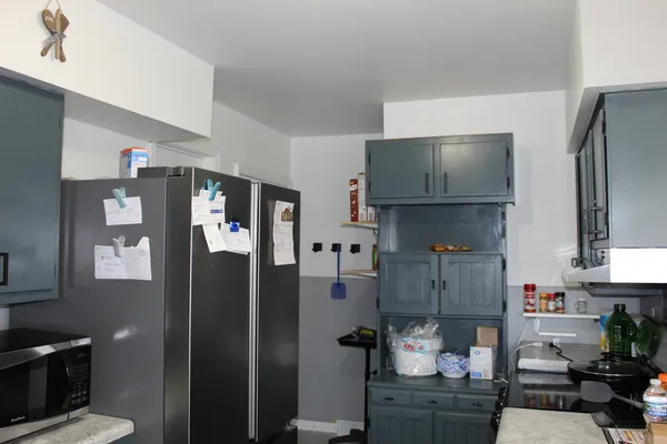 a kitchen with stainless steel appliances a refrigerator and cabinets