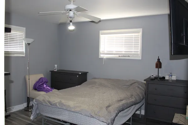 a bedroom with a bed and a window