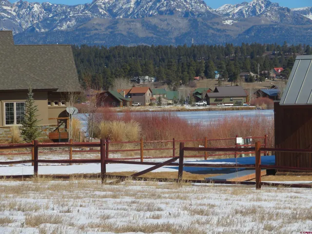 a view of a lake with a house in the background