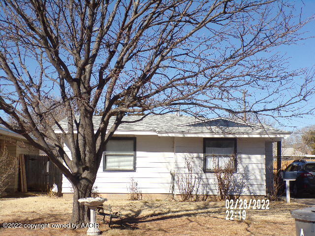 a large tree in front of a house