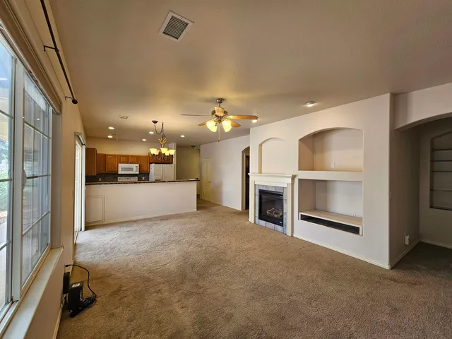 a view of a hallway with an empty room and a fireplace