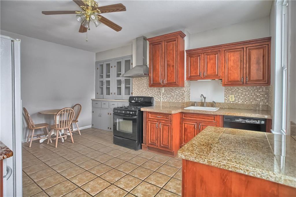 5151 Carnegie Street Pittsburgh, PA 15201 - Photo 5 of 16 The kitchen provides charm and character, with a small eat-in area.