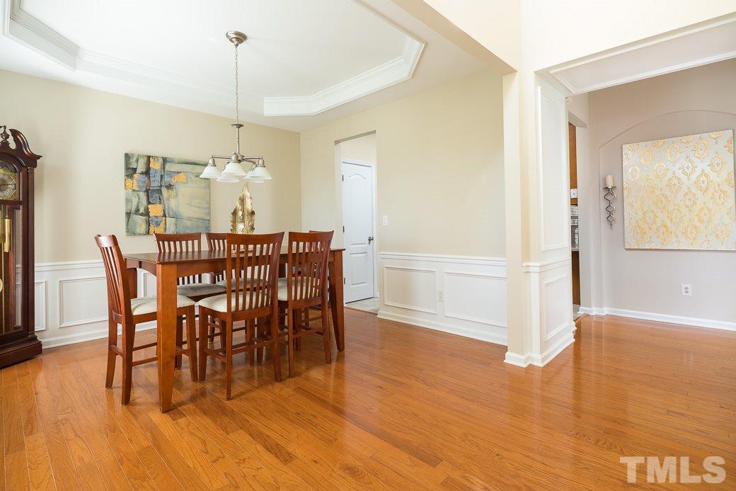 3315 Colorcott Street Raleigh, NC 27614 - Photo 2 of 21 a view of a dining room and livingroom with furniture wooden floor a chandelier