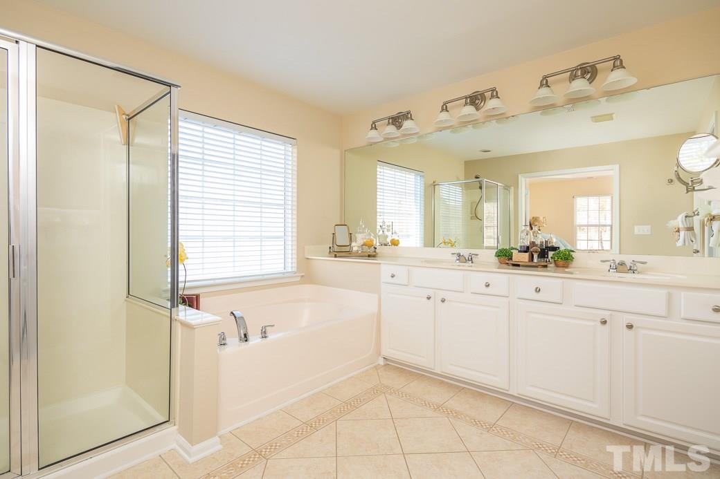 3315 Colorcott Street Raleigh, NC 27614 - Photo 10 of 21 a spacious bathroom with a granite countertop sink and a mirror