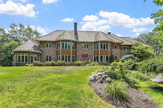 a front view of a house with a garden