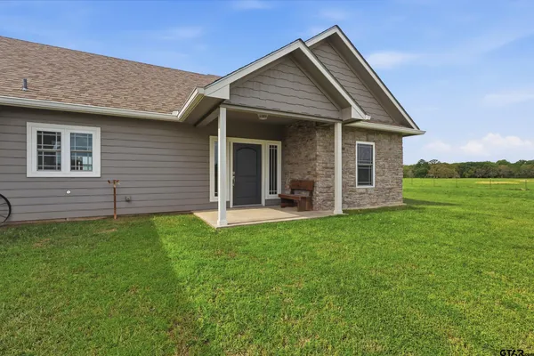a view of a house with a backyard