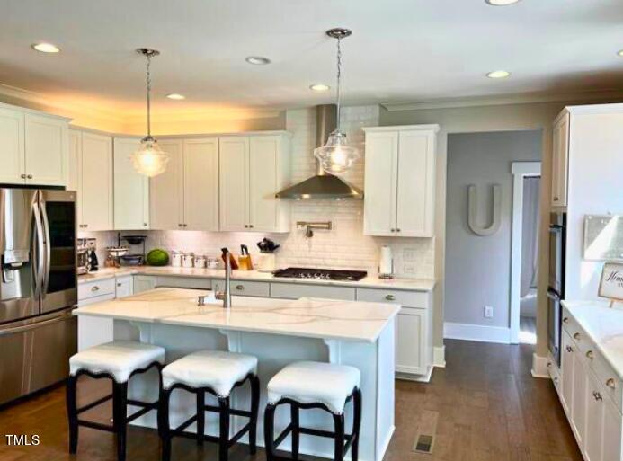 3015 Freeman Farm Way Rolesville, NC 27571 - Photo 11 of 50 a kitchen with stainless steel appliances granite countertop a stove a sink island and a refrigerator