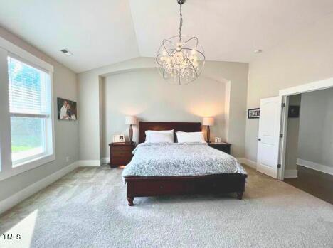 3015 Freeman Farm Way Rolesville, NC 27571 - Photo 27 of 50 a spacious bedroom with a bed and a chandelier