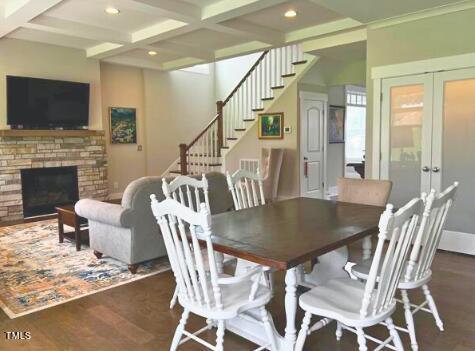 3015 Freeman Farm Way Rolesville, NC 27571 - Photo 10 of 50 a dining room with furniture a flat screen tv and a fireplace