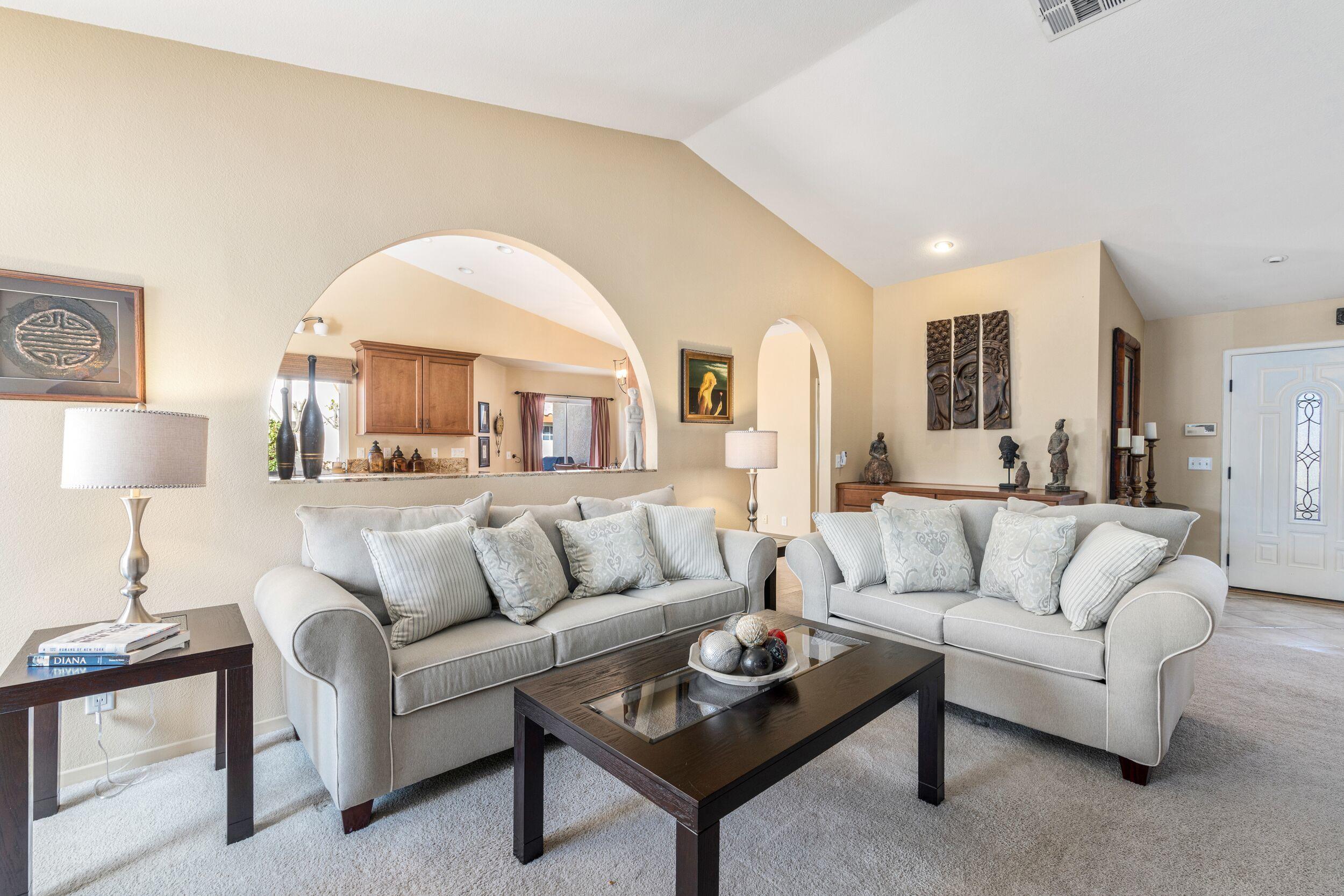 39795 Regency Way Palm Desert, CA 92211 - Photo 11 of 39 a living room with furniture and a lamp