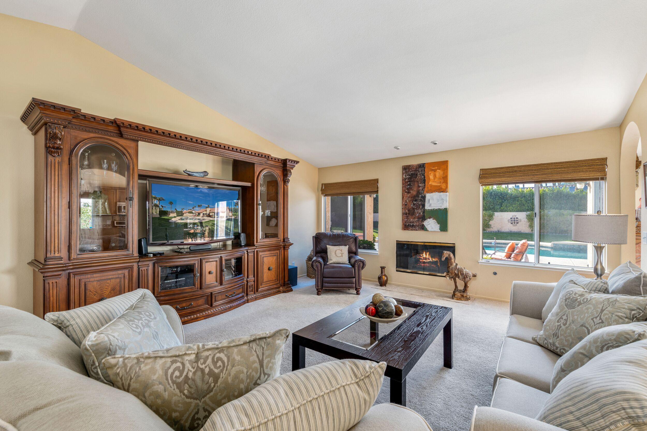 39795 Regency Way Palm Desert, CA 92211 - Photo 12 of 39 a living room with furniture and a flat screen tv