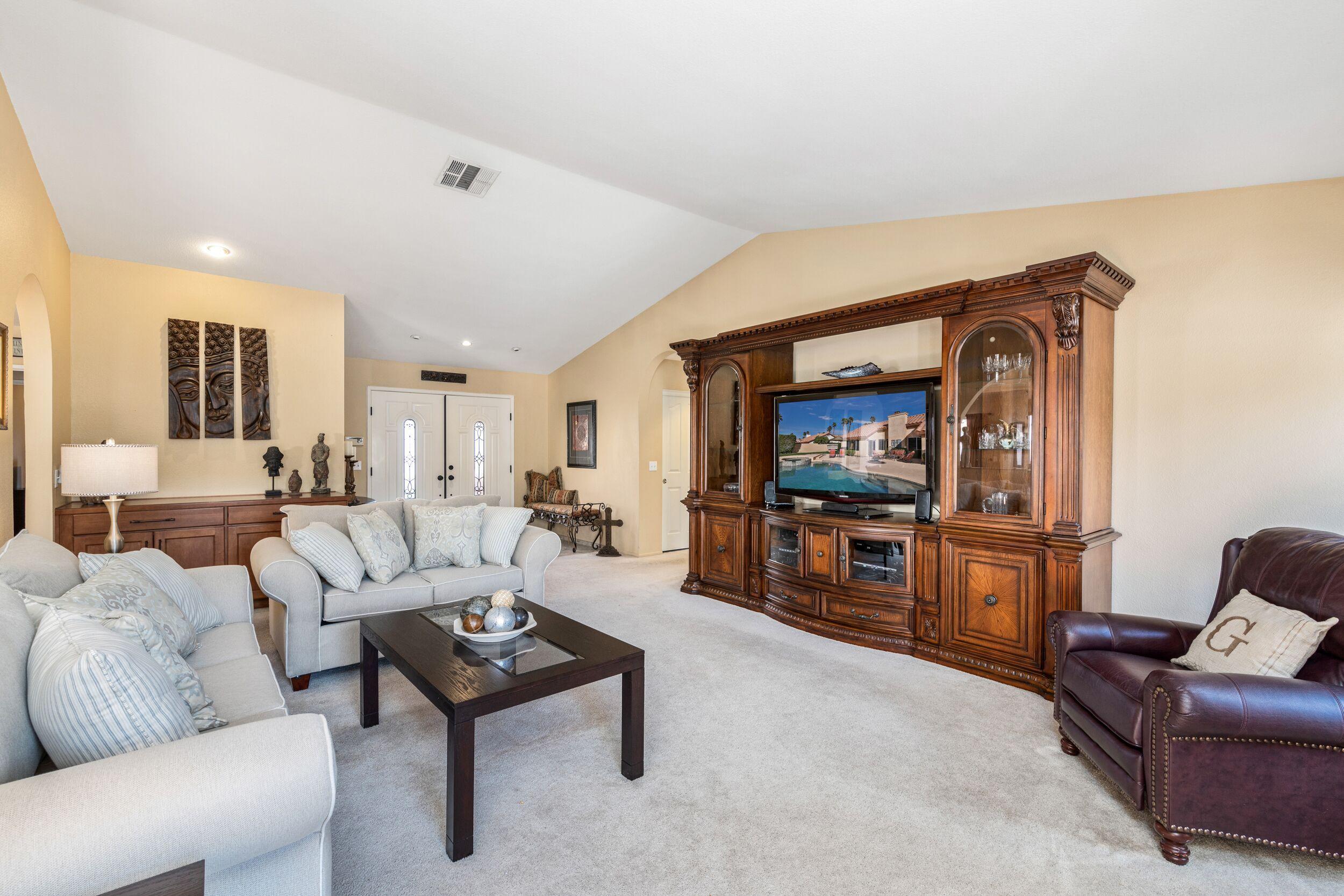 39795 Regency Way Palm Desert, CA 92211 - Photo 13 of 39 a living room with furniture and a flat screen tv