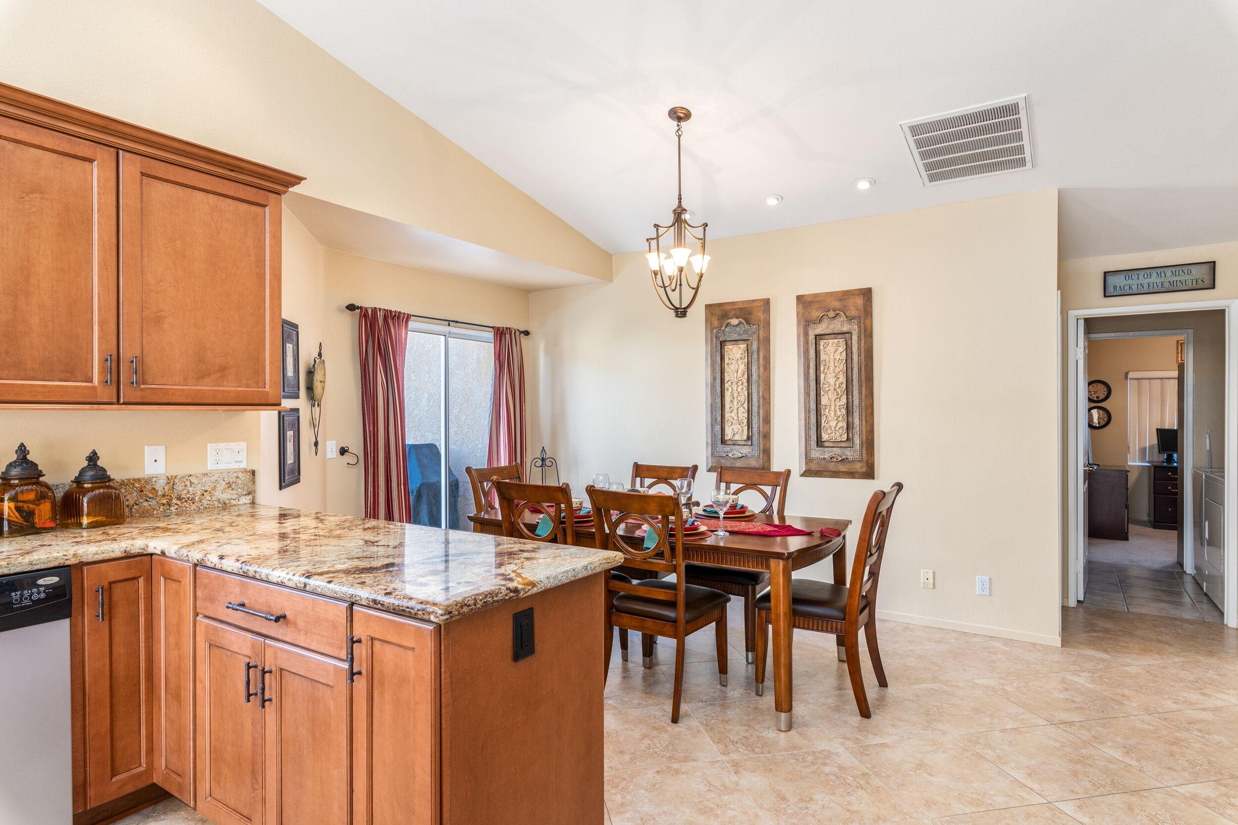 39795 Regency Way Palm Desert, CA 92211 - Photo 14 of 39 a kitchen with a sink and chairs