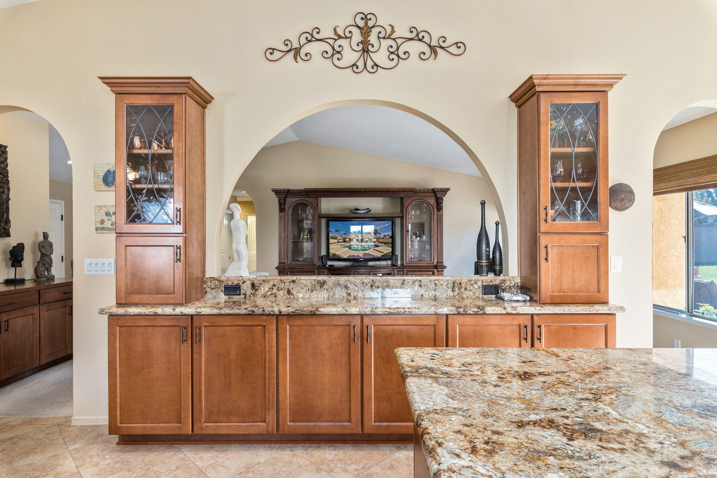 39795 Regency Way Palm Desert, CA 92211 - Photo 17 of 39 a view of a kitchen with granite countertop a sink and a wooden floor