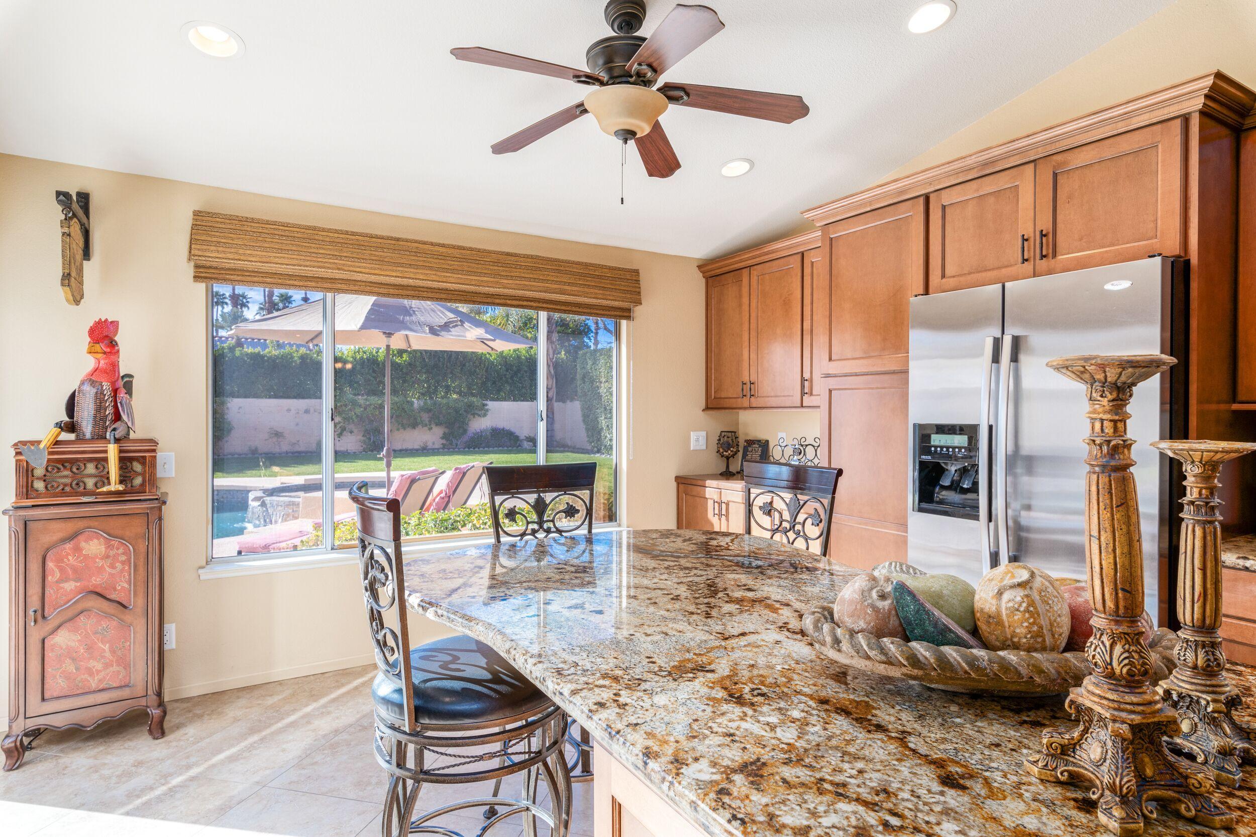39795 Regency Way Palm Desert, CA 92211 - Photo 18 of 39 a living room with furniture a large window and a chandelier