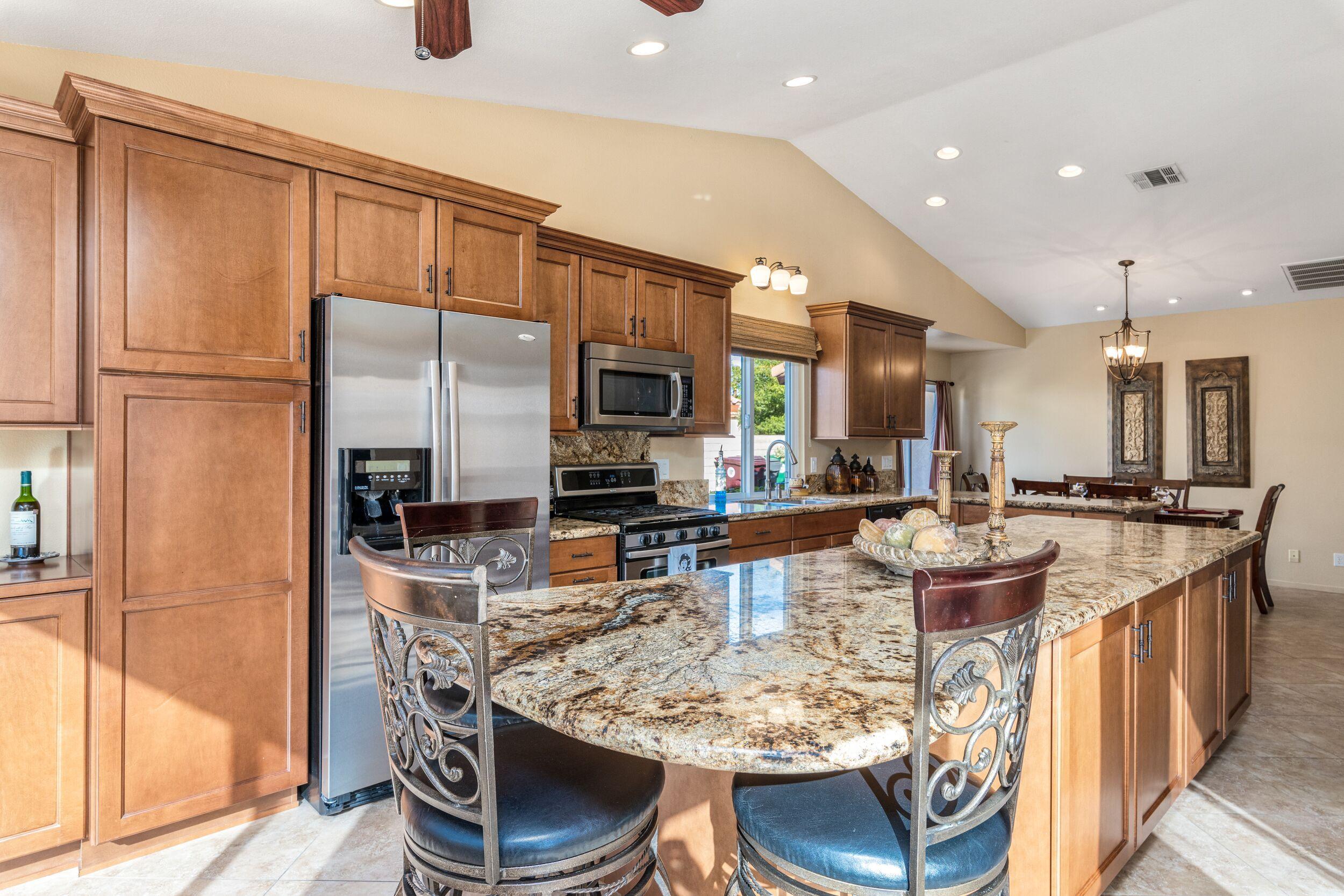 39795 Regency Way Palm Desert, CA 92211 - Photo 20 of 39 a kitchen with stainless steel appliances granite countertop a sink a stove and a refrigerator