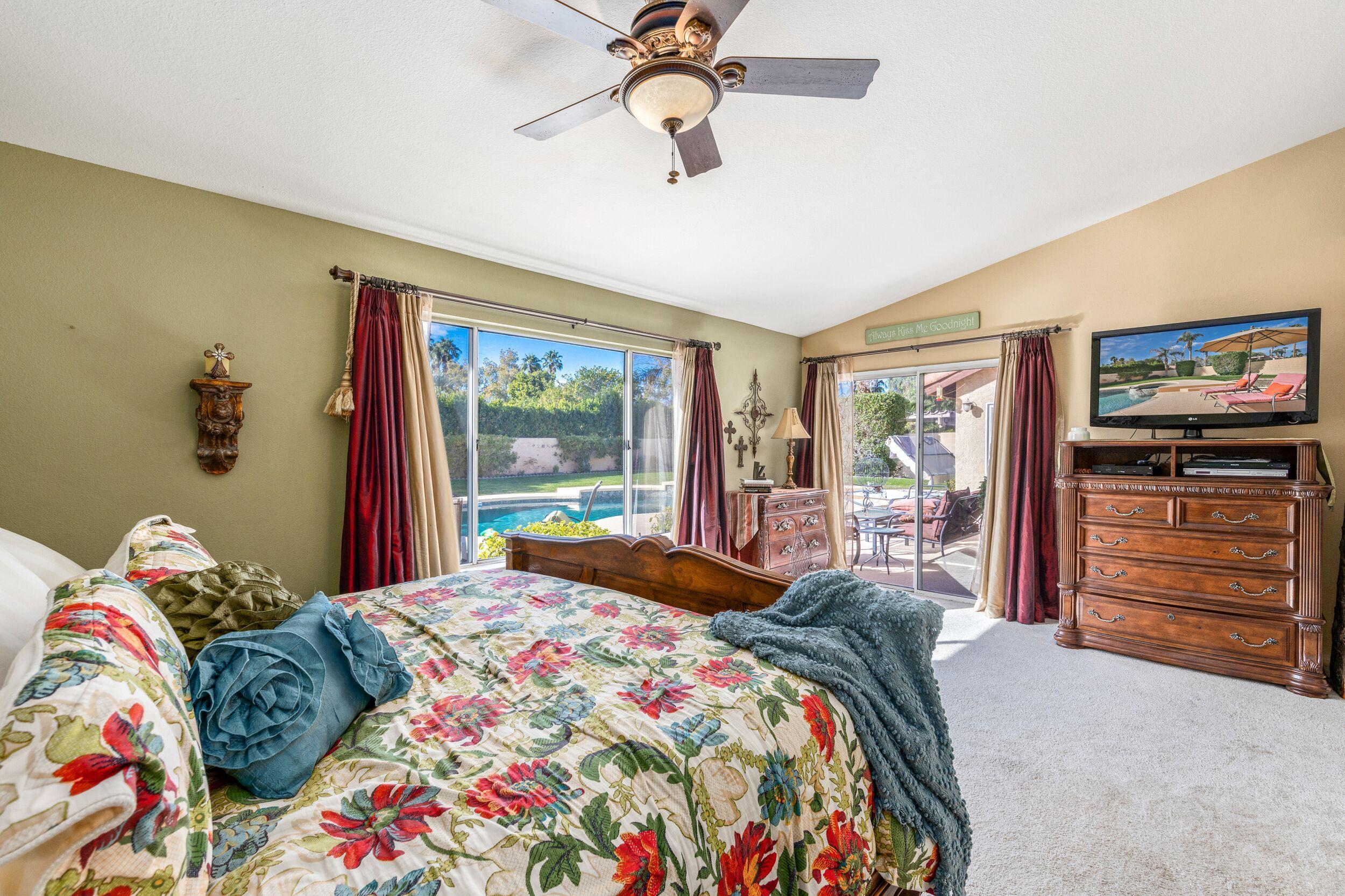 39795 Regency Way Palm Desert, CA 92211 - Photo 23 of 39 a bedroom with a bed and a flat tv screen on dresser