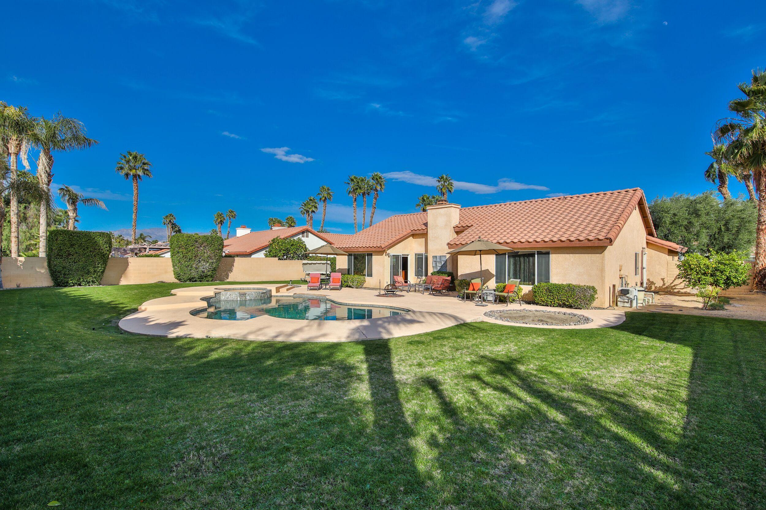 39795 Regency Way Palm Desert, CA 92211 - Photo 33 of 39 a view of a house with swimming pool and a yard