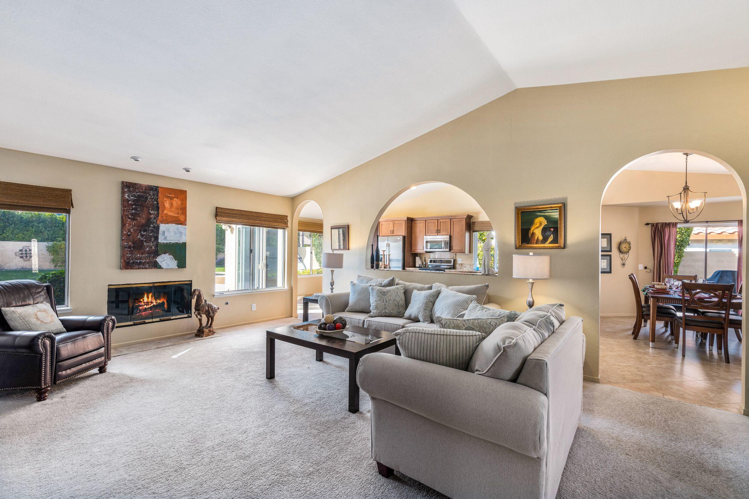 39795 Regency Way Palm Desert, CA 92211 - Photo 4 of 39 a living room with furniture and a fireplace